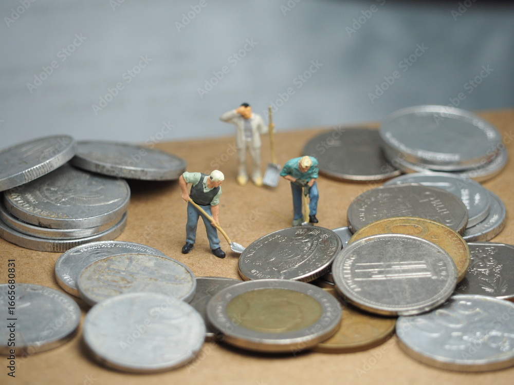 Fototapeta premium Mini toy at table with blurred background. Financial and economic photography concept design.