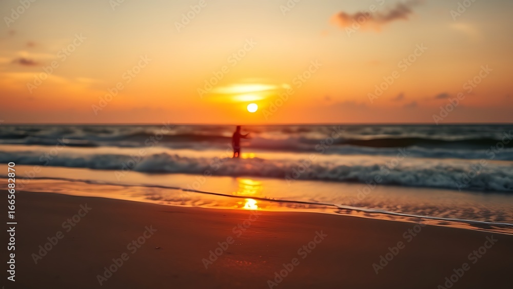 Obraz premium Sunset at the beach with golden light and distant silhouettes of a family.