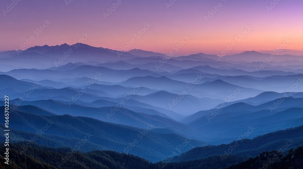Obraz premium Serene sunset over layered, hazy mountains