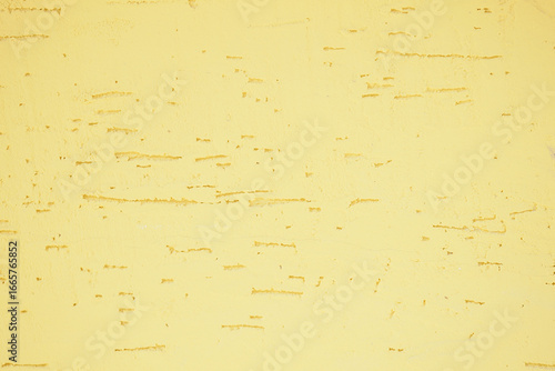 Yellow textured wall with visible imperfections and detail
