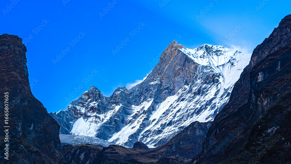 Fototapeta premium Mt. Fishtail (Machapuchare) Himalayan Snow Peak at Dusk under Blue Sky