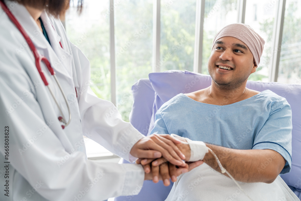 Fototapeta premium A male cancer patient in a wheelchair receives IV therapy while a female doctor offers care encouragement and updates on his test results providing support and discussing health progress