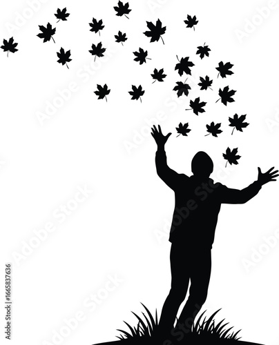 Silhouette of a man throwing autumn leaves in air, enjoying fall season