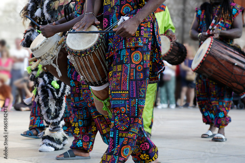 Men playing playing drums and wearing one of the traditional costume from Dakar, Senegal