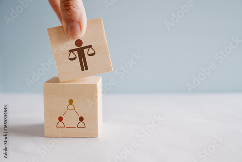 Foto Hand holding wooden block with Ethics icons, business compliance justice discipline regulation concept