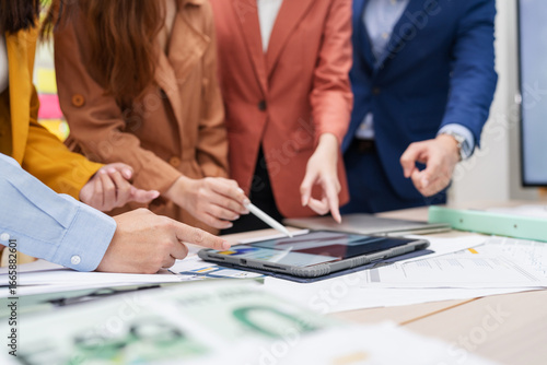 Business meeting showcases agile brainstorming with data analysis charts on tablets. Financial growth prediction strategy through predictive analytics and data-driven insights for strategic business 