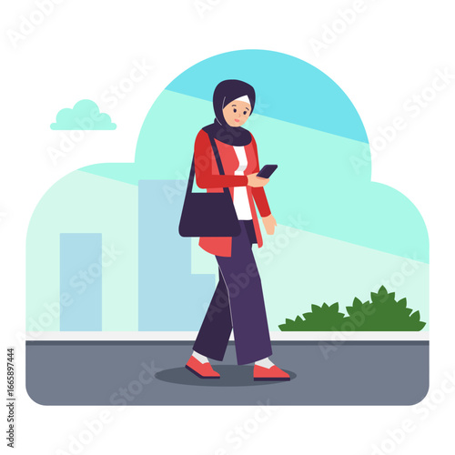 Beautiful female student wearing hijab walking carrying a sling bag and using a smartphone, woman in walking in the city.
