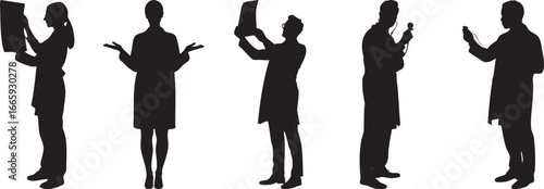 Silhouette of medical professionals in lab coats examining xrays and using equipment