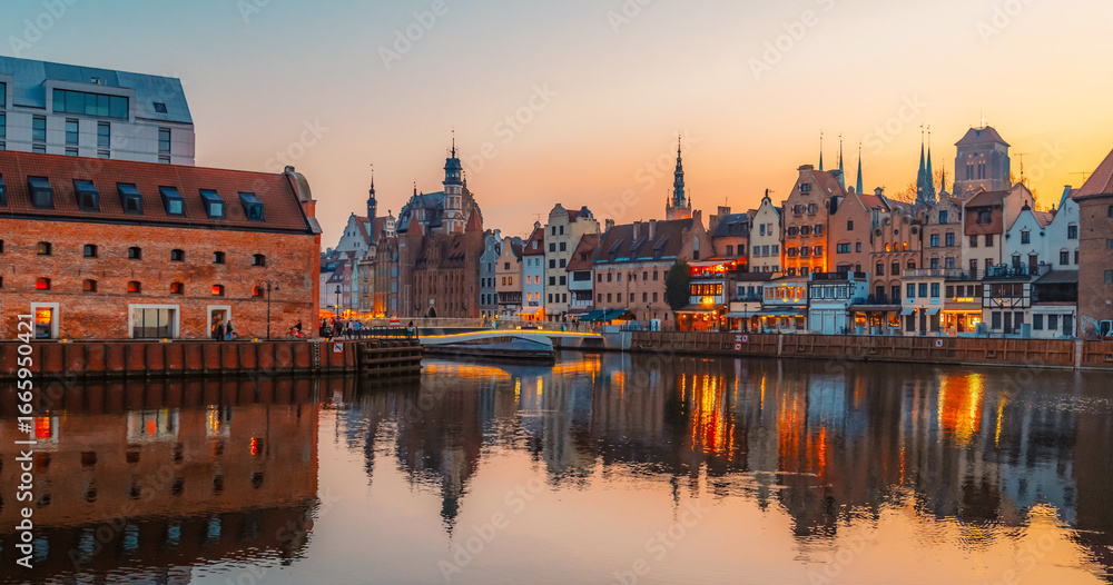Fototapeta premium Gdansk with Motlawa river in Poland. Old town colourful house with Zuraw or crane and with Holy Spirit Gate