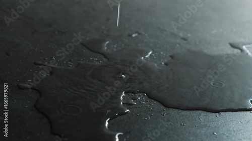 A leaking roof and water pouring onto the floor creating a large puddle.
A puddle on the floor and drops of water flowing down.
Splashes of water hitting the puddle.
Puddle, water, streak, leak