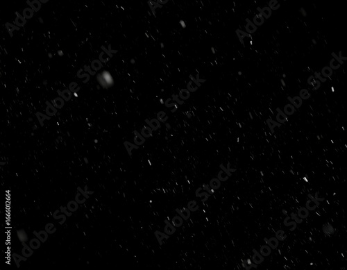 Falling snow against a black background, creating a textured effect