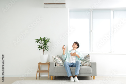 Young man resting on sofa i...