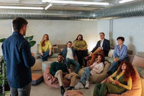 Принти на полотні Creative director leading a brainstorming meeting with his team in a modern offi