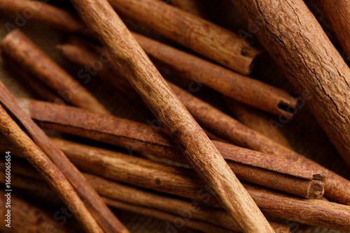 Cinnamon sticks dried tree bark spice on rustic background.