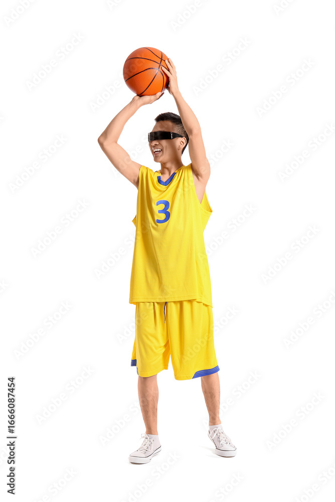 Fototapeta premium Sporty young Asian man in AR glasses playing basketball on white background