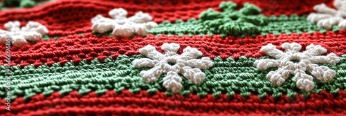 Closeup of a Festive Christmas Crochet Blanket with Red and Green Stripes and White Snowflake Appliqu?s
