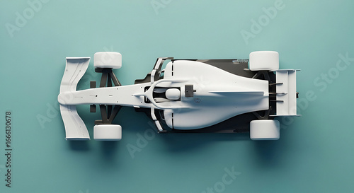 Overhead view of a sleek white modern formula 1 race car model on a muted teal surface in studio lighting
