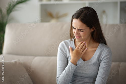 Foto Woman suffering throat ache complaining at home