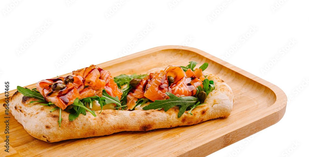Tasty flatbread with smoked salmon and greens on a wooden board Tasty flatbread with smoked salmon and greens on a wooden board