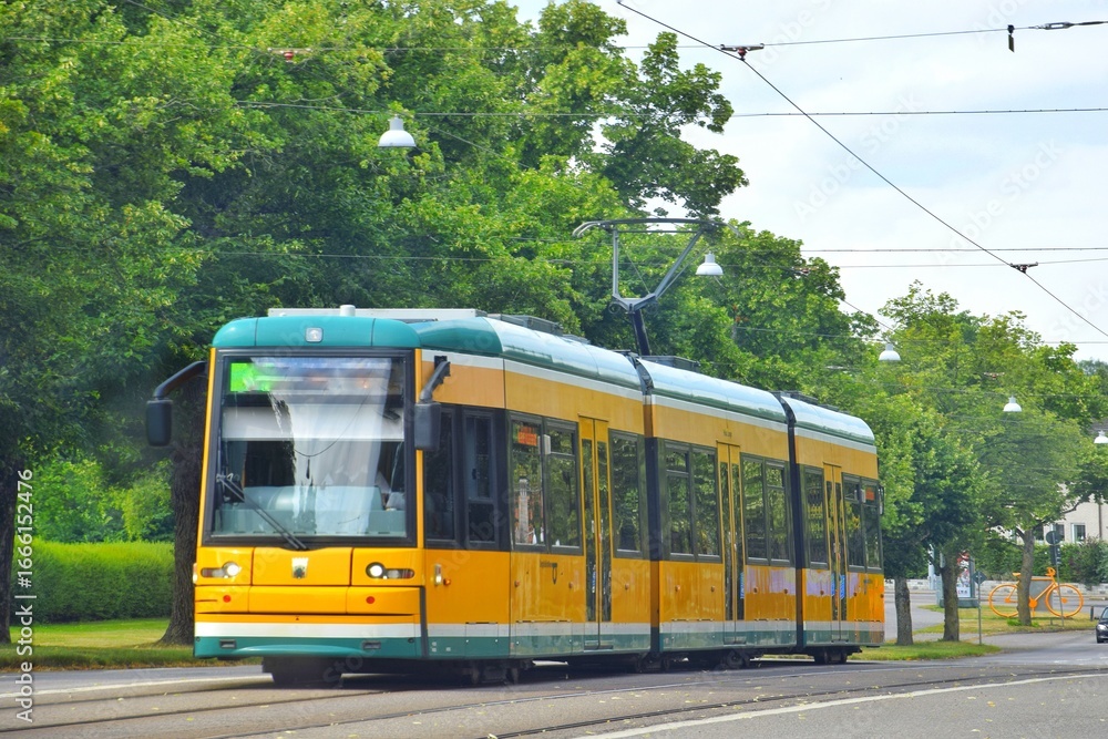 Naklejka premium Yellow tram on the city street.