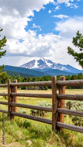 Mountain vista through a wooden fence