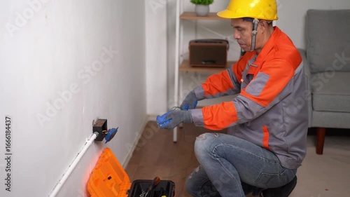 Skilled Electrician Working on Home Electrical System with Tools and Safety Gear in Contemporary Living Space