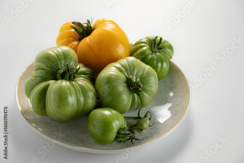 Wallpaper Mural Colorful assorted heirloom tomatoes displayed on a ceramic plate against a light background Torontodigital.ca