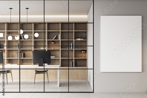 Fototapeta Naklejka Na Ścianę i Meble -  Modern corporate office interior with sleek furniture, bookshelves, and a vertical blank canvas mockup on a clean gray wall background. 3D Rendering