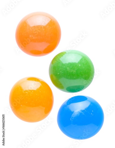 Vibrant round candies in orange, green, and blue colors are displayed against a plain white background.
