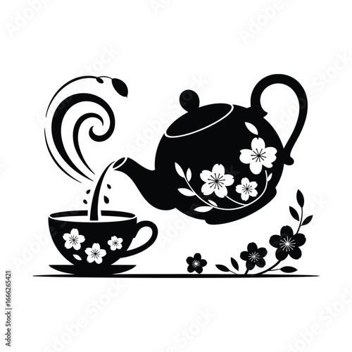 Black teapot pouring tea into cup with floral design