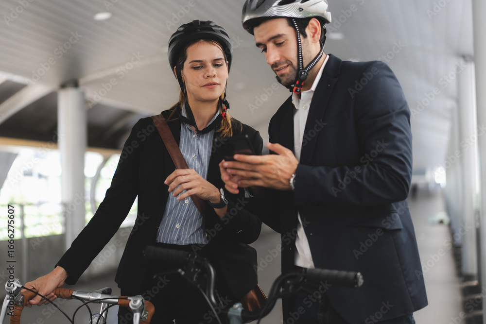 Obraz premium Commuting to work with bicycle. Businessman businesswoman cycling to office in downtown district. Modern diverse people use eco transportation on city street. Environmental pollution, climate change.
