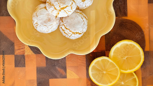 Tablou pe pânză Crinkled lemon cookies bask on a sunflower-yellow plate, invoking zestful solsti