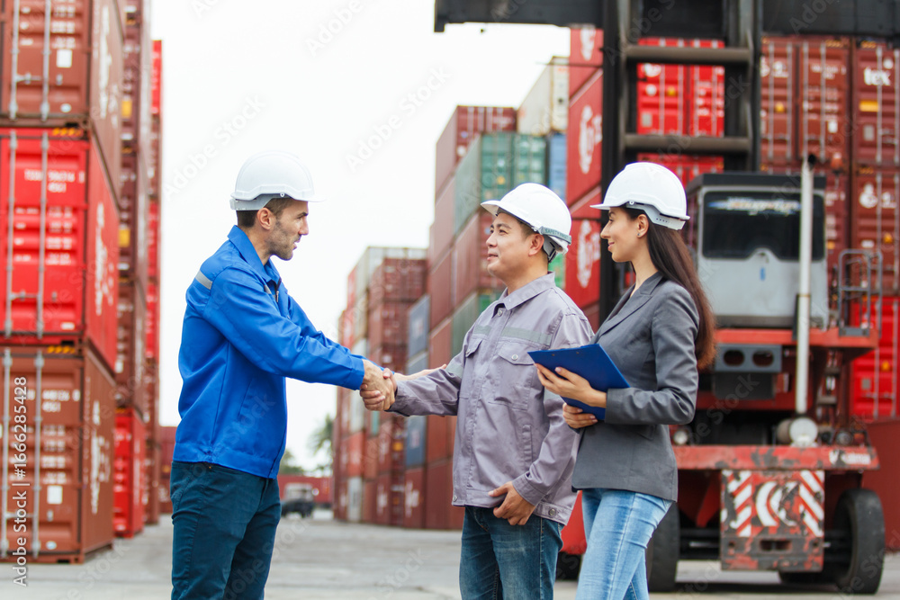 Team of engineers or workers at a container yard discussing seriously and shaking hands to symbolize teamwork and business success. Team of engineers or workers at a container yard discussing seriously and shaking hands to symbolize teamwork and business success.