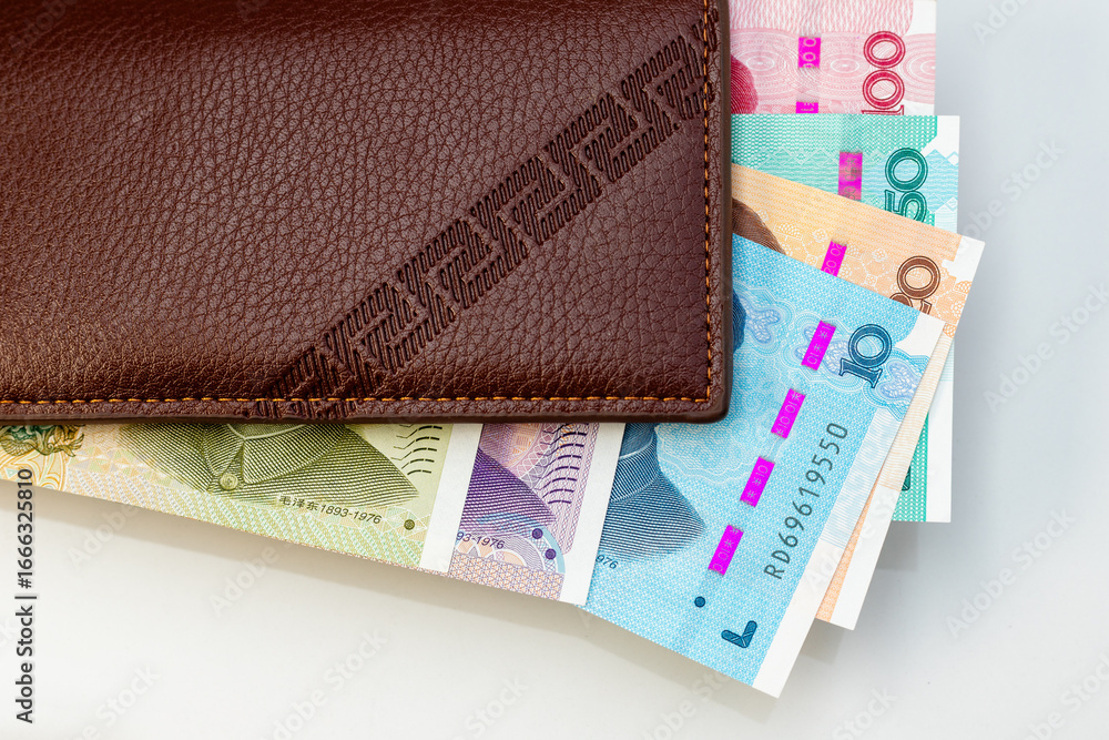 Obraz premium Leather Wallet with Colorful Chinese Yuan Banknotes. Personal Finance Concept.