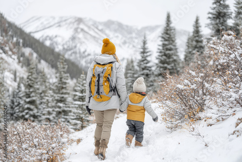 dedicated guide carefully navigates snowy mountain trail with child in arms exemplifying warmth of family outings