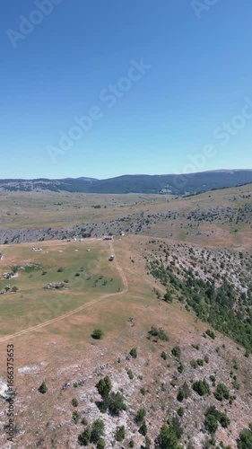 Aerial drone footage showing winding dirt roads across a mountain rural area, symbolizing countryside travel, adventure and outdoor exploration.