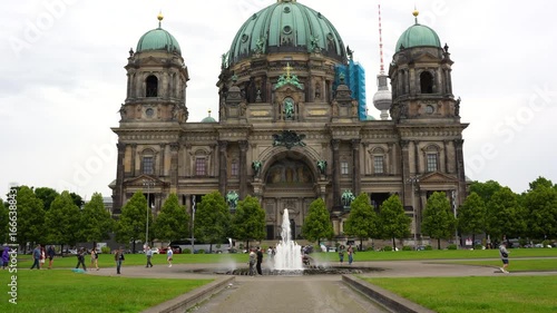 Berlin, Germany - June 1, 2025: Grand view of the Berliner Dom, featuring its impressive domed roof, intricate architectural details, and a tranquil fountain in the foreground on a cloudy day.