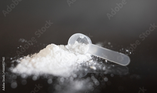 Close-up of creatine powder with spoon.