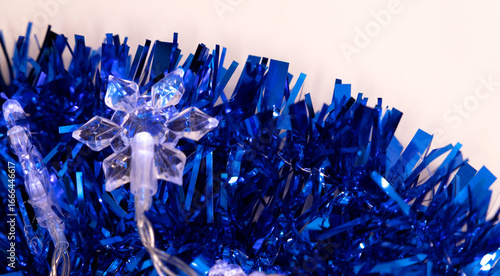 snow-shaped light on blue tinsel