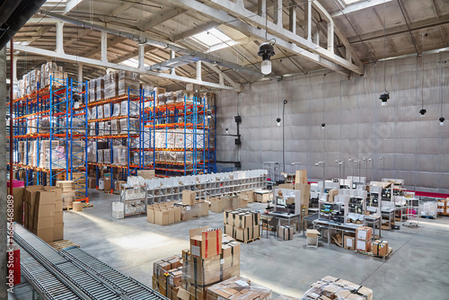 Spacious Warehouse Interior with Stocked Racks and Conveyor