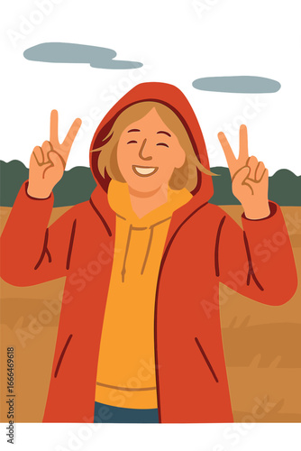 A carefree woman dons a raincoat and flashes a peace sign while strolling in the park