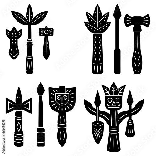 Collection of black and white tribal ceremonial objects including spears and decorated clubs or staffs