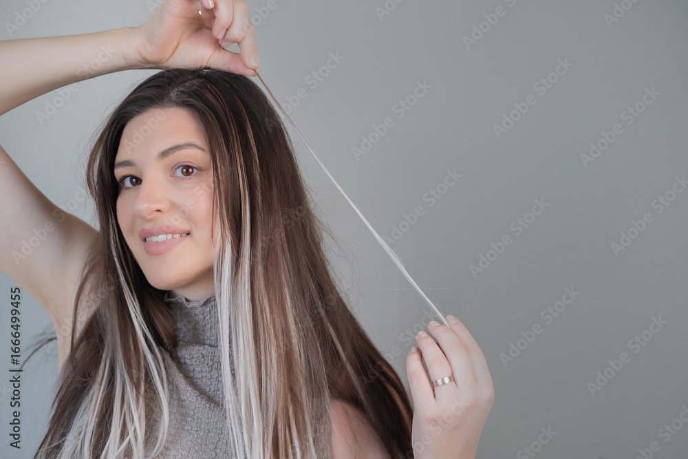 Fototapeta premium Hairdresser applying capsule hair extensions modern technique for adding length and volume in beauty salon
