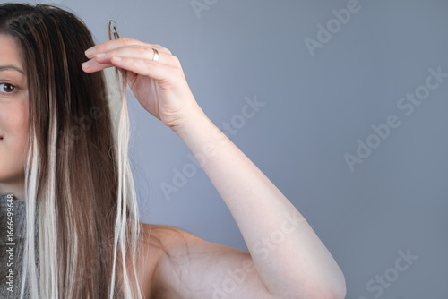 Hairstylist creating long hairstyles using hair extensions professional salon work with beautiful results
