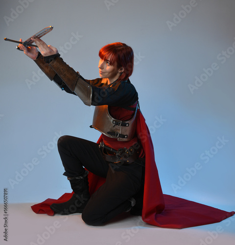 Φωτογραφία Fantasy warrior woman model wearing historical medieval armour costume, red fairytale cloak, cinematic portrait of strong fantasy knight
