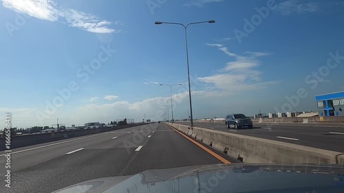 highway driving POV bright blue sky