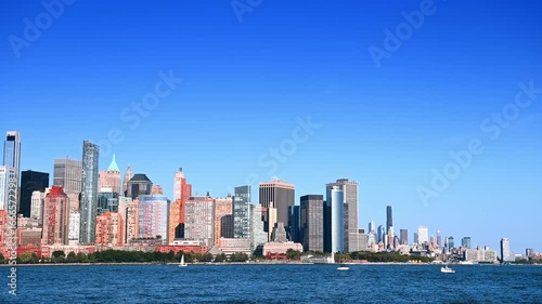 Modern urban skyline of beautiful Manhattan on clear sunny day. View across the blue waterscape of the Hudson River from Jersey.
