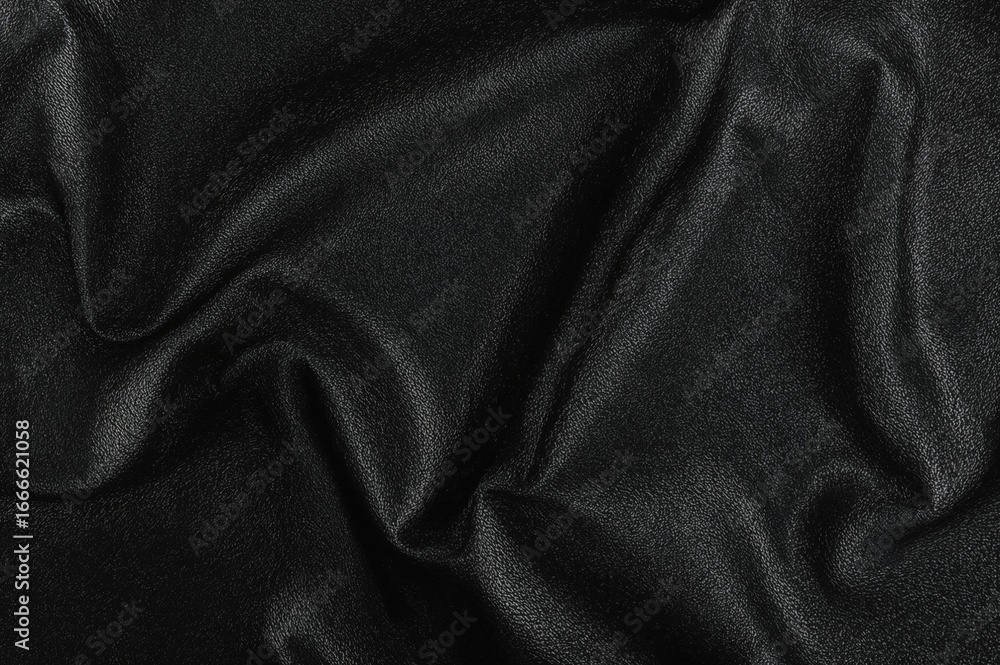 Fototapeta premium Synthetic black leather featuring waves and creases on a PVC foundation