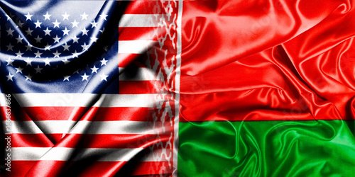 The national flags of the United States and Belarus, merging into one, are located next to each other on a fluttering cotton background. Flags.