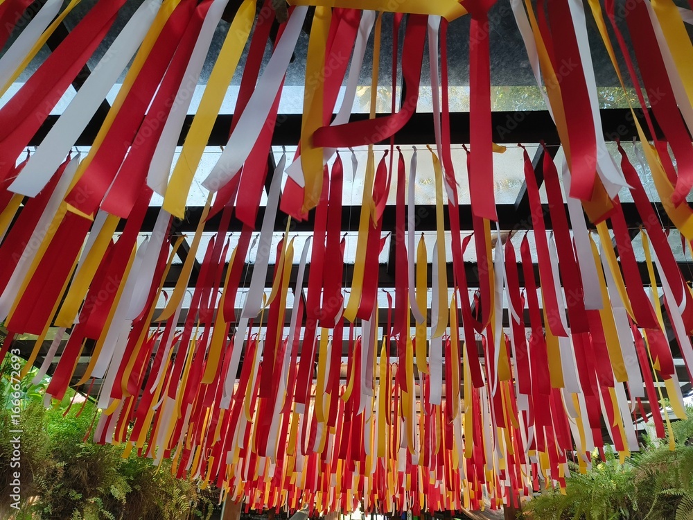 Obraz premium Multicolored ribbons hung over the walkway.